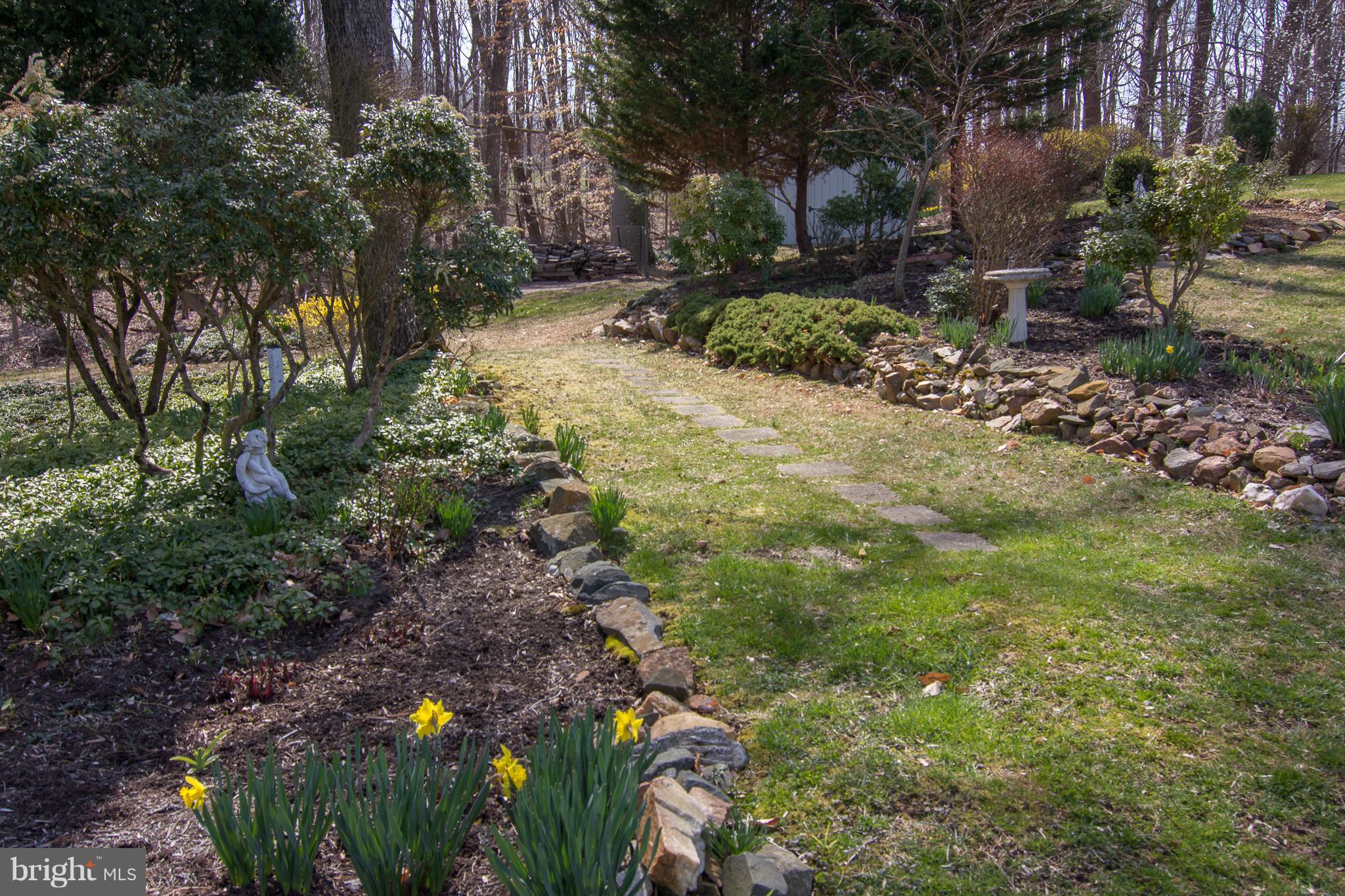1104 Sturbridge Road Fallston, MD 21047 - Photo 26 of 28 a backyard of a house with lots of green space and fountain