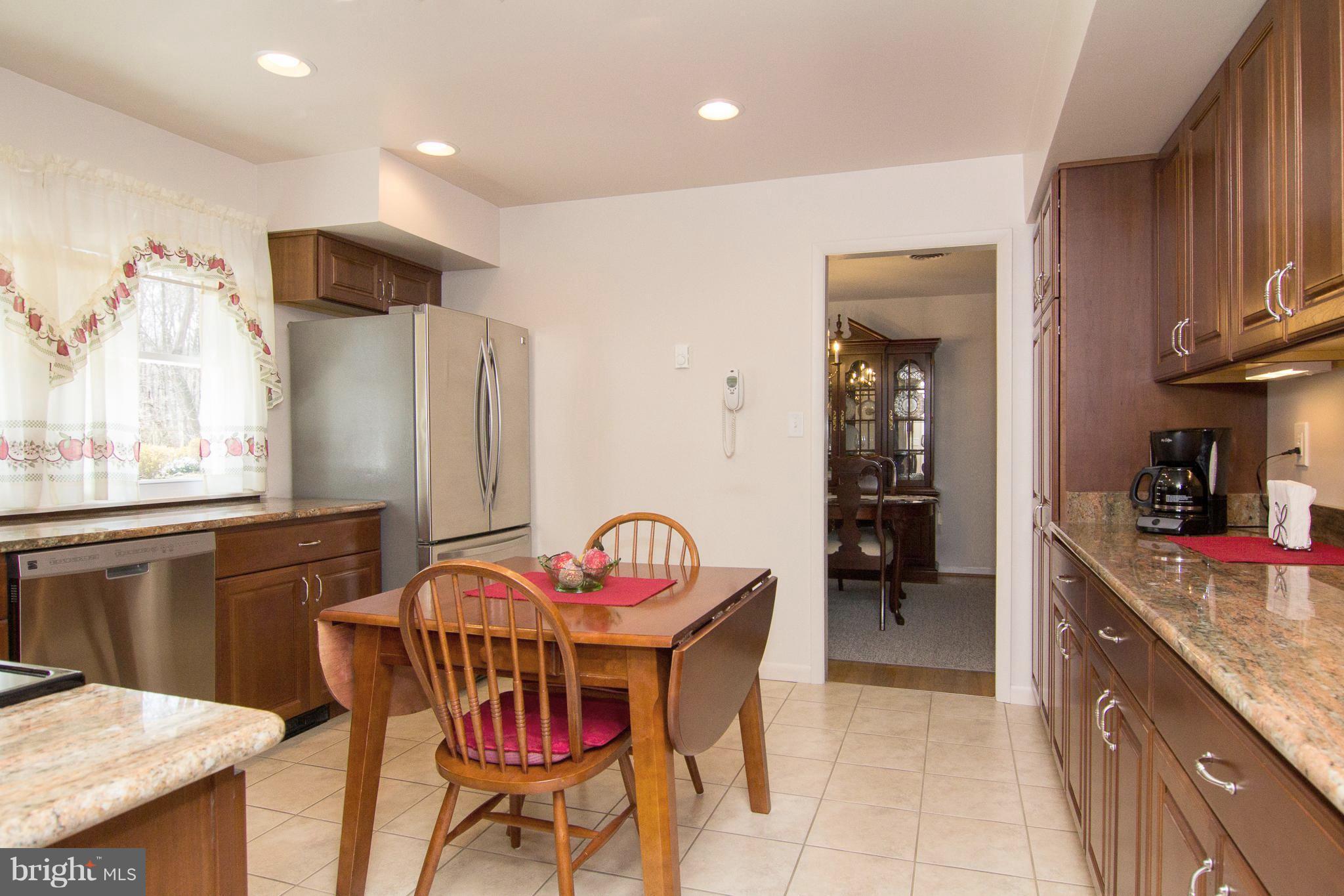 1104 Sturbridge Road Fallston, MD 21047 - Photo 6 of 28 a kitchen with stainless steel appliances kitchen island granite countertop a dining table chairs sink and cabinets