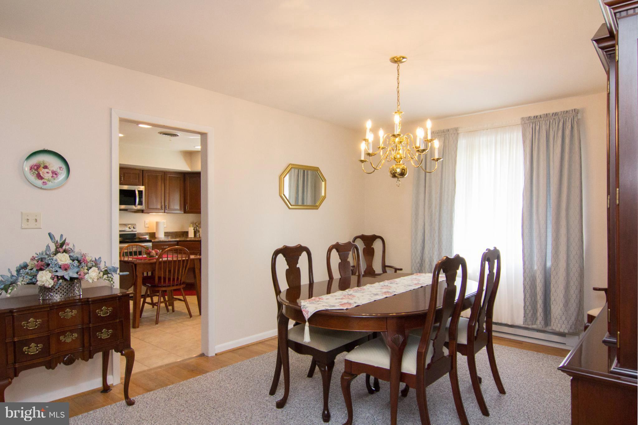 1104 Sturbridge Road Fallston, MD 21047 - Photo 7 of 28 a view of a dining room with furniture and chandelier