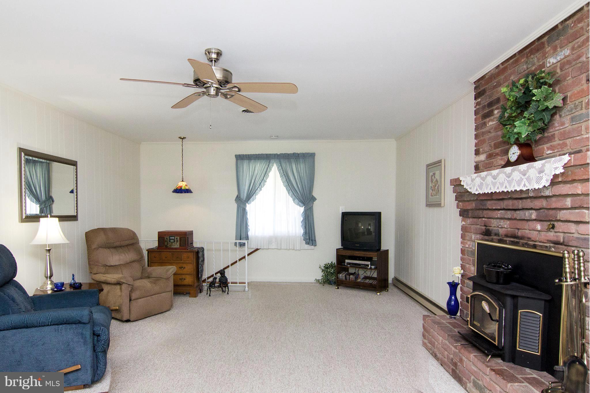 1104 Sturbridge Road Fallston, MD 21047 - Photo 9 of 28 a living room with furniture a fireplace and a flat screen tv