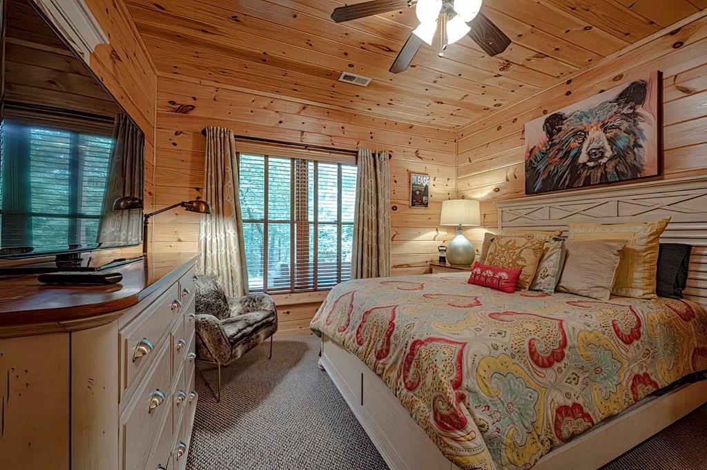 35 Leatherwood Mountain Road Cherry Log, GA 30522 - Photo 12 of 58 a bedroom with a bed next to a large window with the outer view