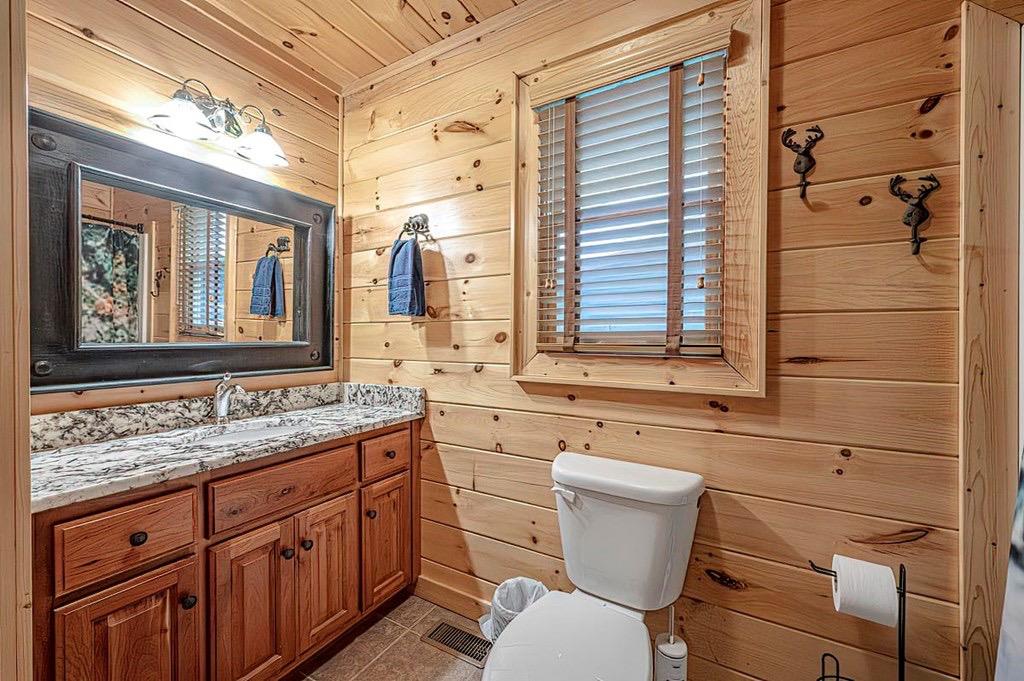 35 Leatherwood Mountain Road Cherry Log, GA 30522 - Photo 15 of 58 a bathroom with a granite countertop toilet sink and mirror