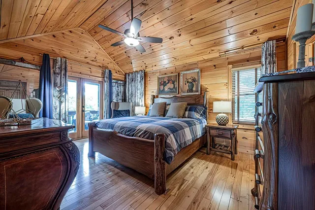 a bed sitting in a bedroom next to a large window