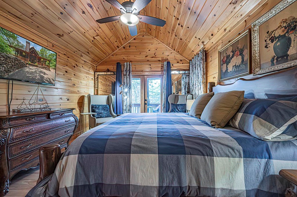35 Leatherwood Mountain Road Cherry Log, GA 30522 - Photo 21 of 58 a bed sitting in a bedroom next to a large window