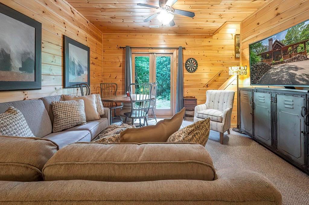 35 Leatherwood Mountain Road Cherry Log, GA 30522 - Photo 25 of 58 a living room with furniture and a flat screen tv