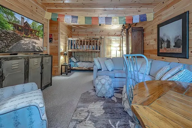 a bed sitting in a bedroom next to a window