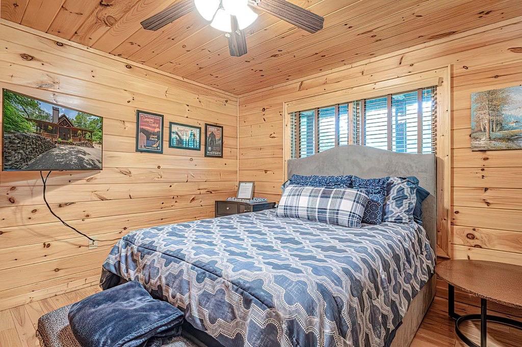 35 Leatherwood Mountain Road Cherry Log, GA 30522 - Photo 29 of 58 a bed sitting in a bedroom next to a window