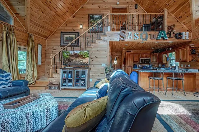 a living room with furniture a fireplace and a table