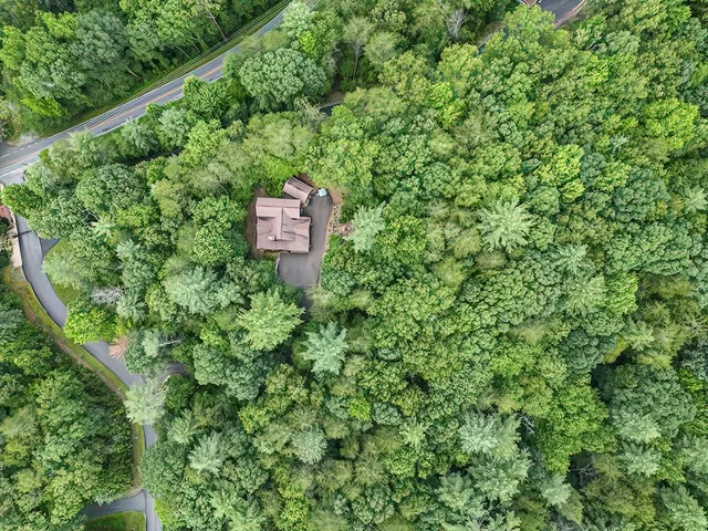 an aerial view of a house with a yard