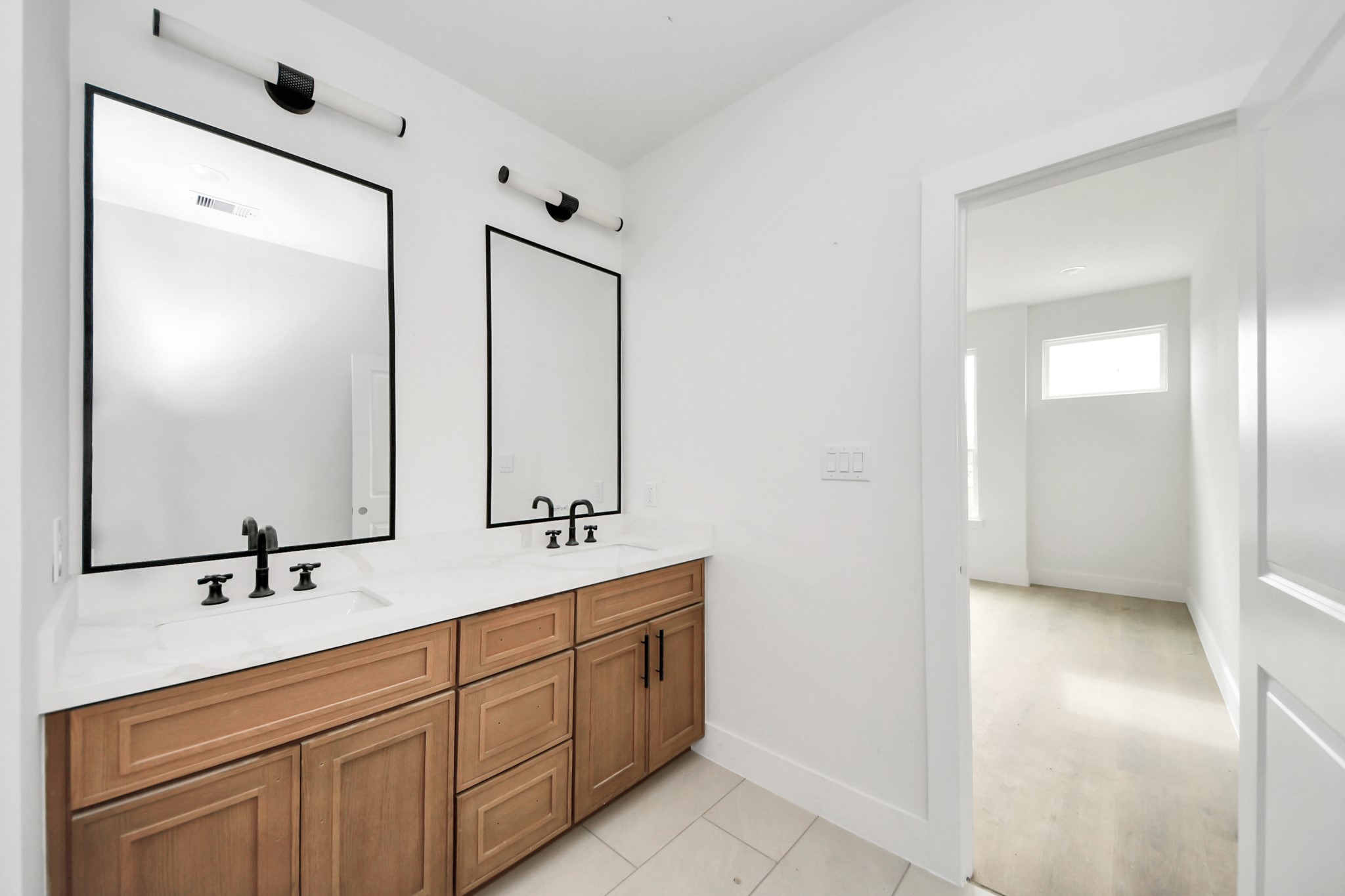 8206 Colonial Lane Houston, TX 77051 - Photo 28 of 31 a bathroom with a double vanity sink and mirror
