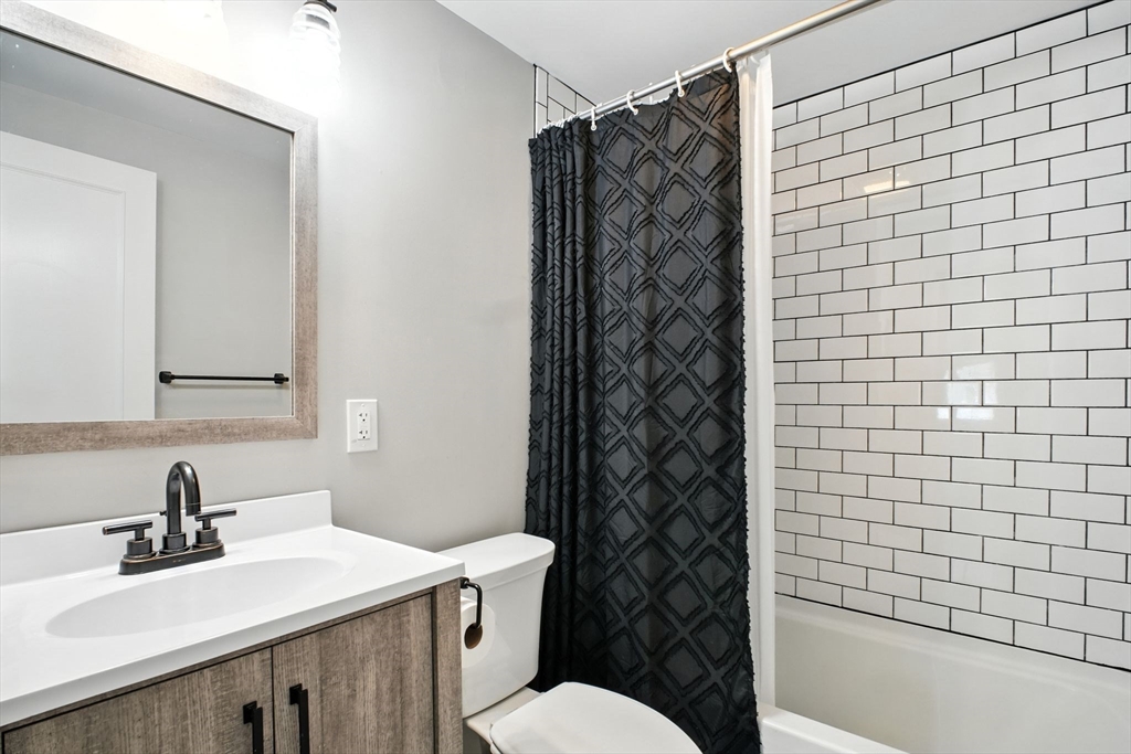 19 Harbour Road Springfield, MA 01118 - Photo 23 of 28 a bathroom with a sink a toilet and shower curtain