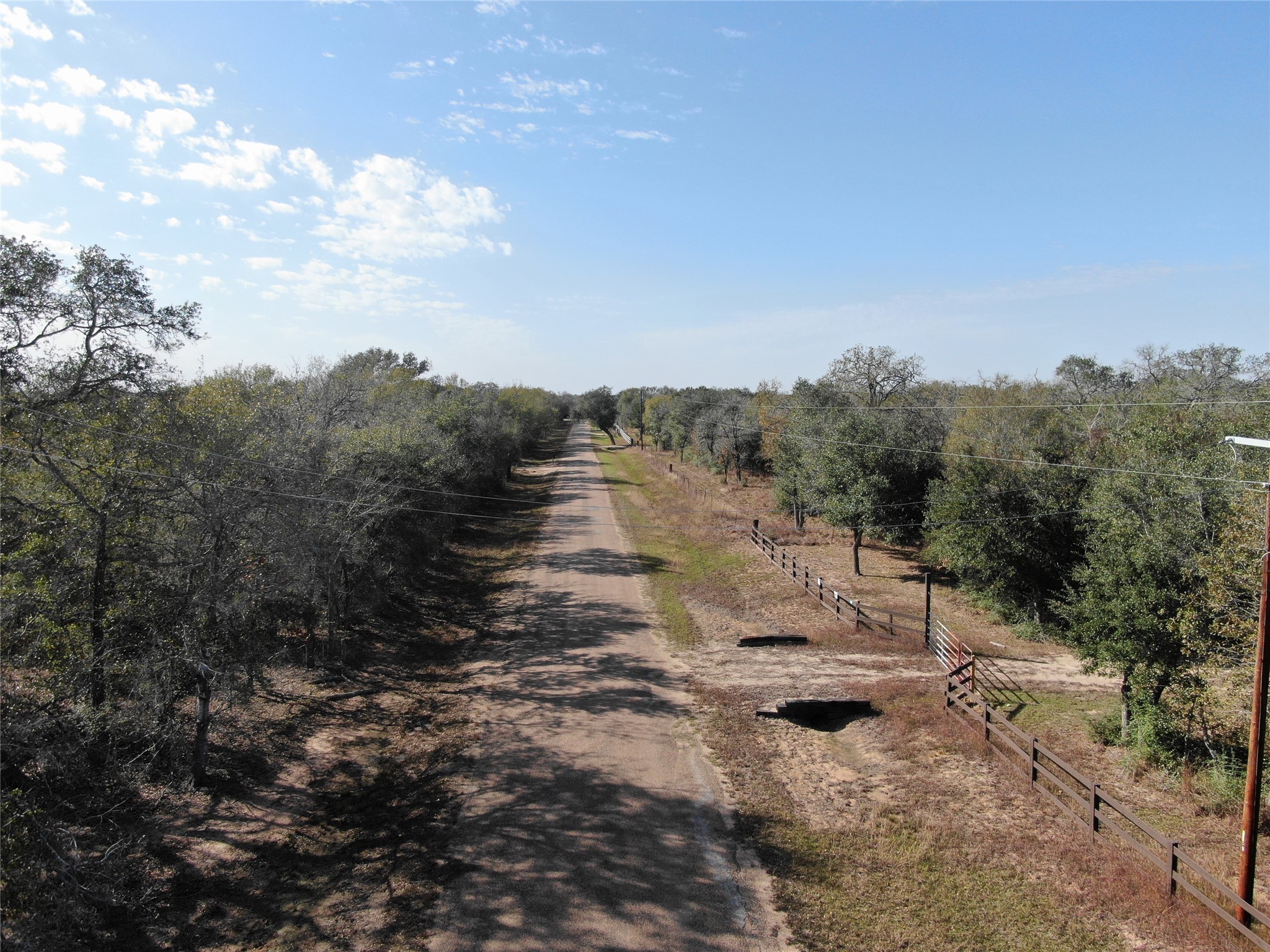 1044 Reeves Road Garwood, TX 77442 - Photo 17 of 18 a view of a yard with wooden fence