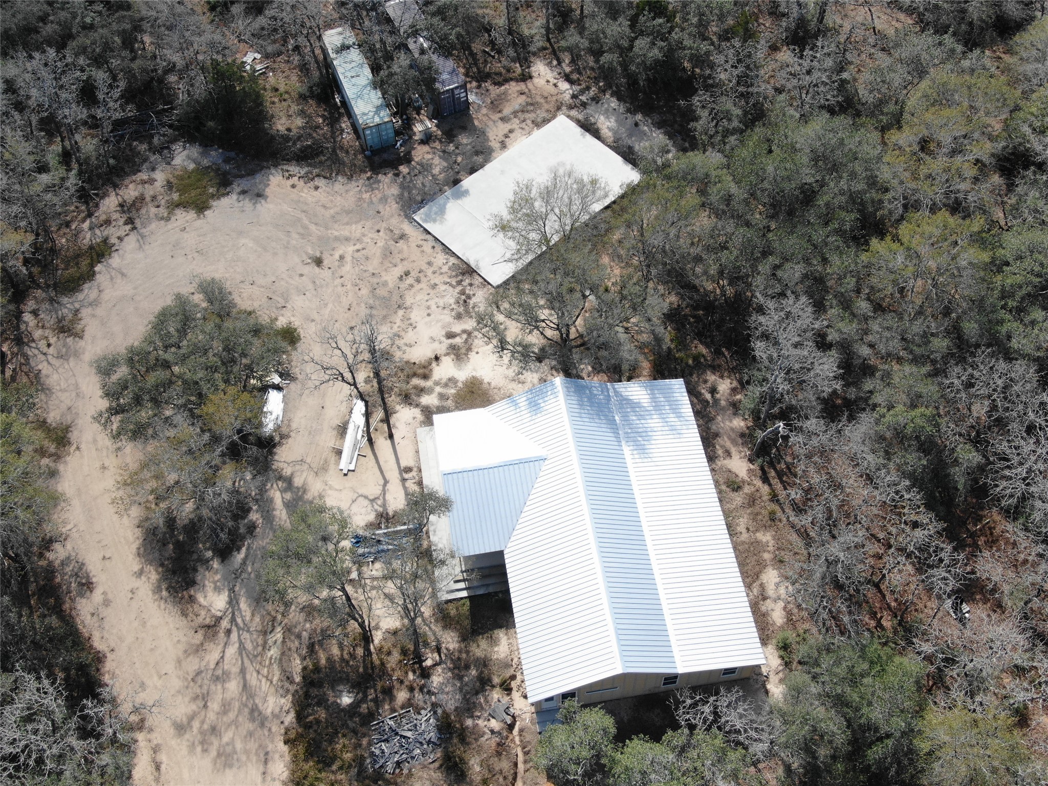 1044 Reeves Road Garwood, TX 77442 - Photo 4 of 18 a view of house with yard and covered with trees