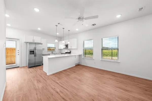 a view of kitchen with wooden floor and window