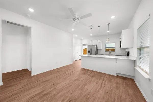 a view of a hallway with wooden floor