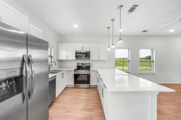 a kitchen with granite countertop a sink and a stove top oven