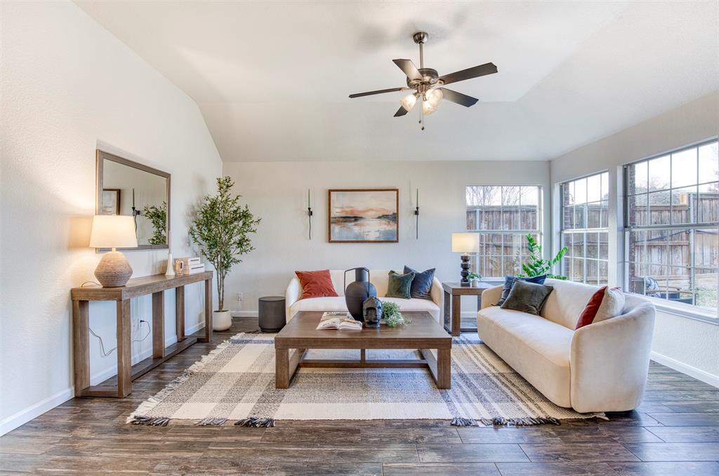 10814 Spring Lake Road Frisco, TX 75035 - Photo 13 of 40 a living room with furniture and a wooden floor