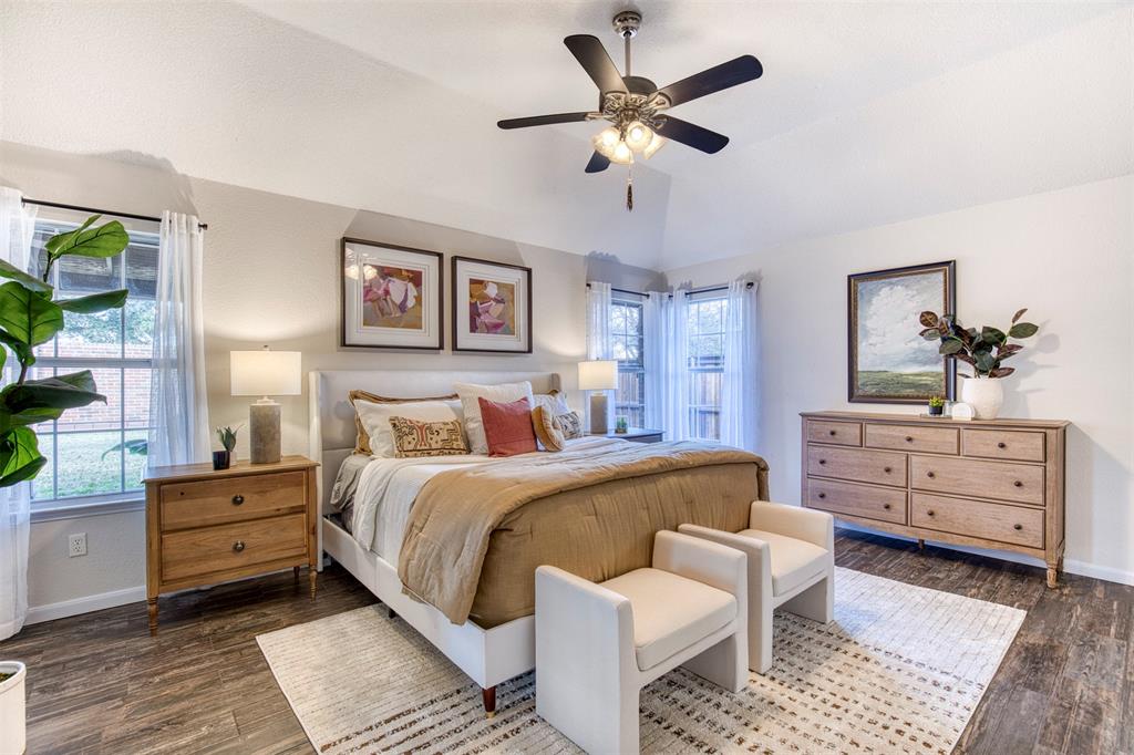 10814 Spring Lake Road Frisco, TX 75035 - Photo 17 of 40 a bed room with a bed and a chandelier