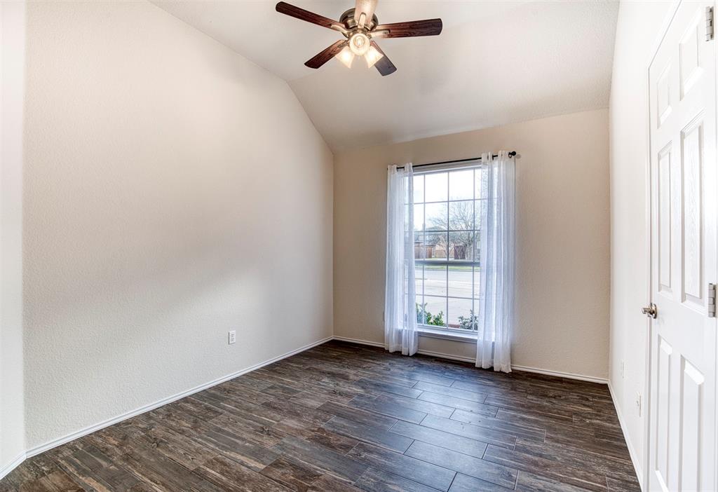 10814 Spring Lake Road Frisco, TX 75035 - Photo 19 of 40 an empty room with wooden floor fan and windows