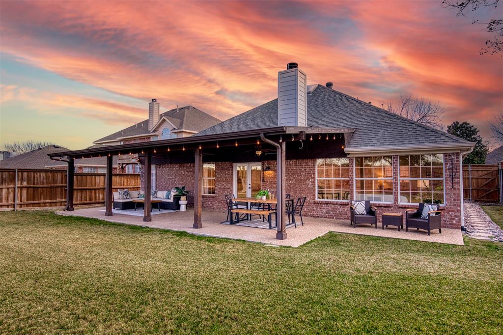 10814 Spring Lake Road Frisco, TX 75035 - Photo 25 of 40 a view of a house with a patio outdoor seating space and garden