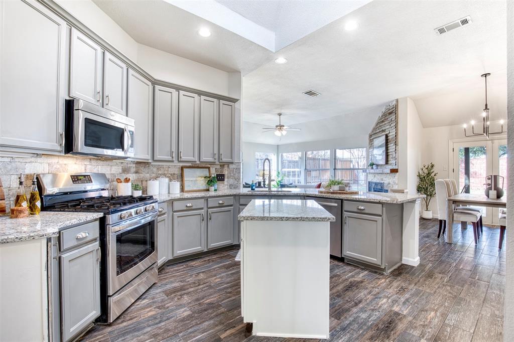 10814 Spring Lake Road Frisco, TX 75035 - Photo 7 of 40 a kitchen with a sink stove and cabinets