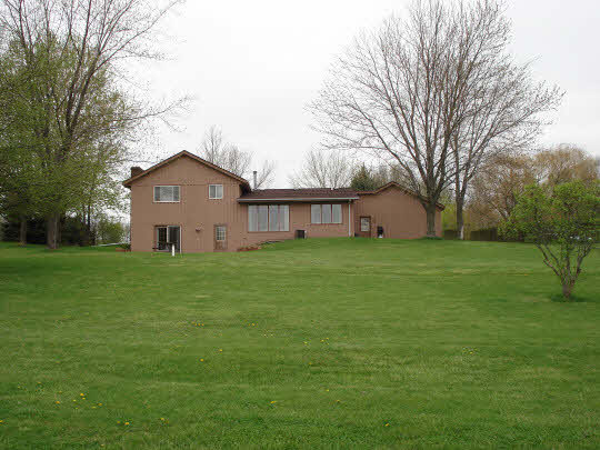 7823 East Rockton Road Roscoe, IL 61073 - Photo 6 of 6 a view of a house with a big yard