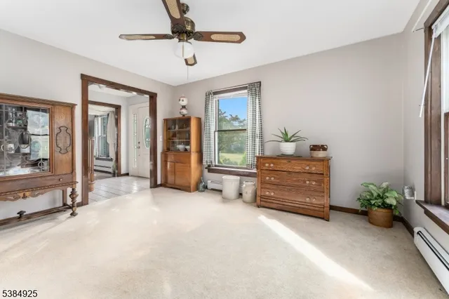 a view of room with furniture and a ceiling fan