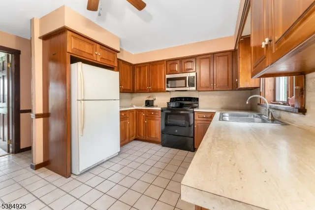 a kitchen with a refrigerator sink and stove