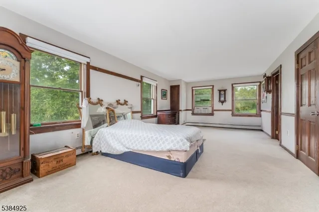 a spacious bedroom with a large bed and a large window