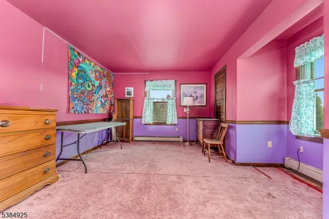 a view of a room with furniture and window