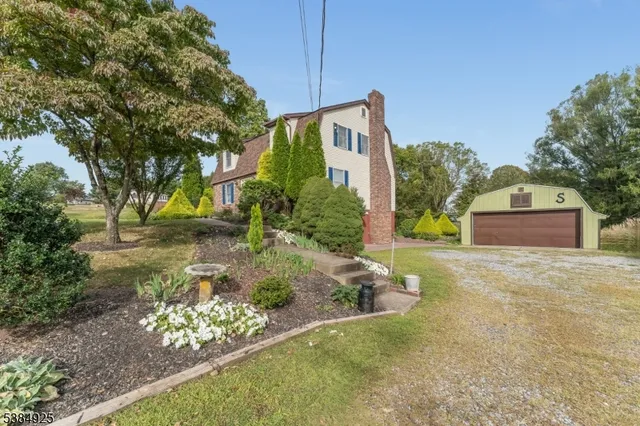 a front view of a house with a yard and outdoor seating