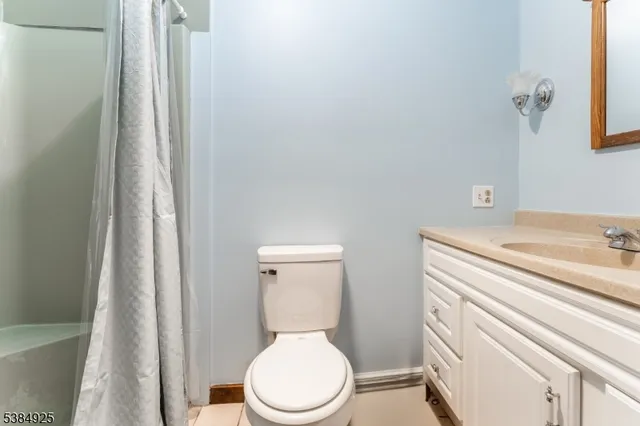 a white toilet sitting next to a bathroom sink