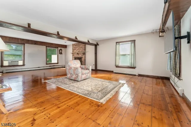 a view of a livingroom with wooden floor and a rug