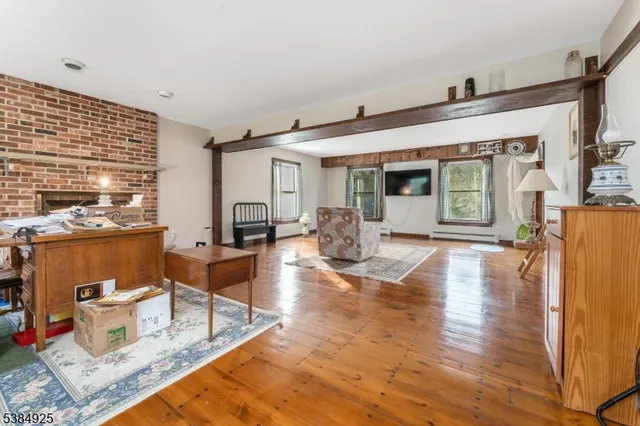 a living room with fireplace furniture and a wooden floor
