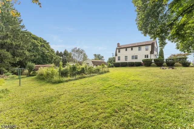 a house view with swimming pool in front of the house