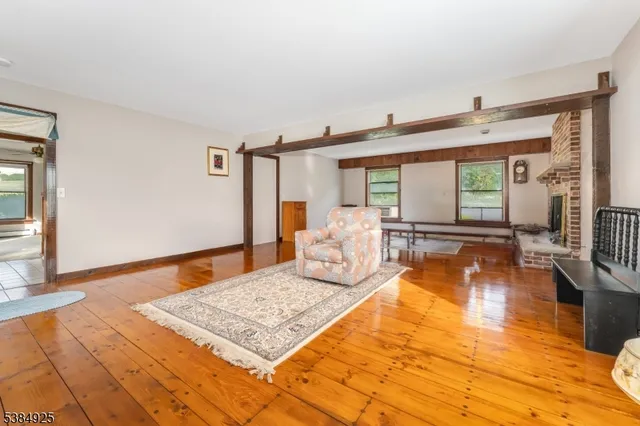 a bedroom with natural light and wooden floor