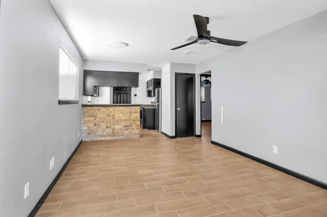 a view of hallway with a sink and a refrigerator