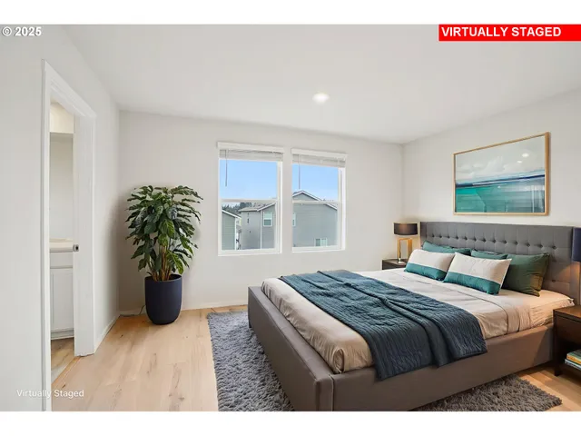 a bedroom with a balcony and a potted plant