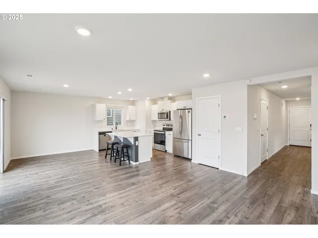 a view of a kitchen with dining table and chairs
