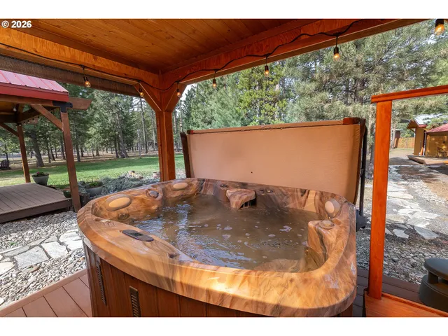 a view of a back yard with a swing chair and table