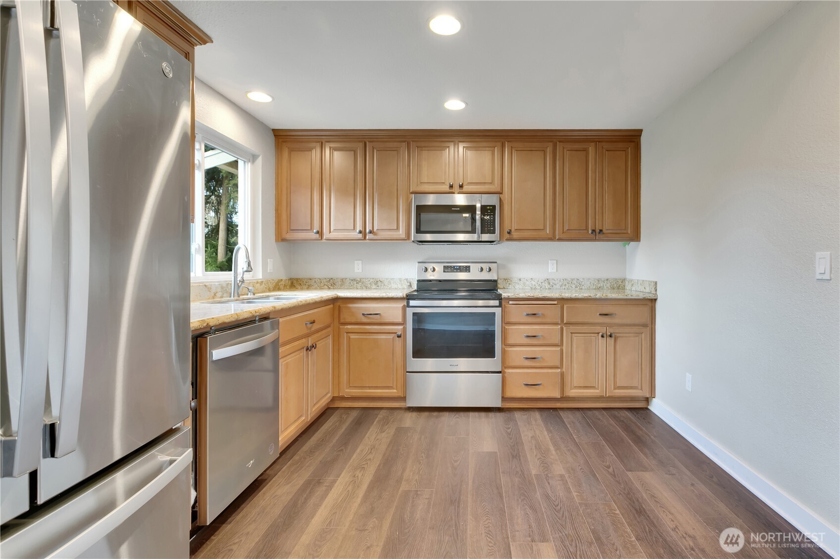32417 29th Avenue Southwest Federal Way, WA 98023 - Photo 11 of 39 a kitchen with a white stove top oven and white kitchen island