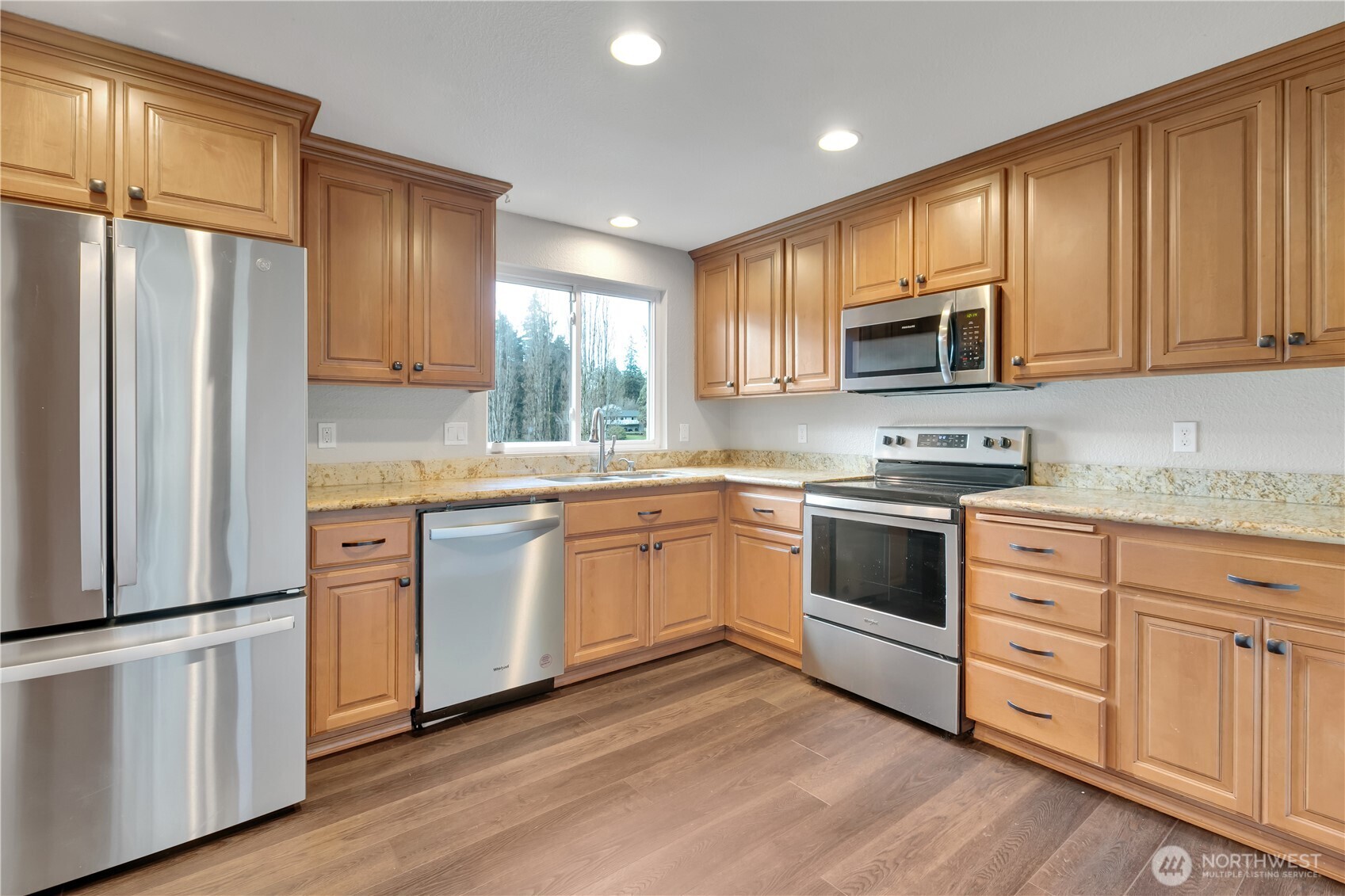 32417 29th Avenue Southwest Federal Way, WA 98023 - Photo 12 of 39 a kitchen with stainless steel appliances granite countertop a refrigerator stove microwave and sink