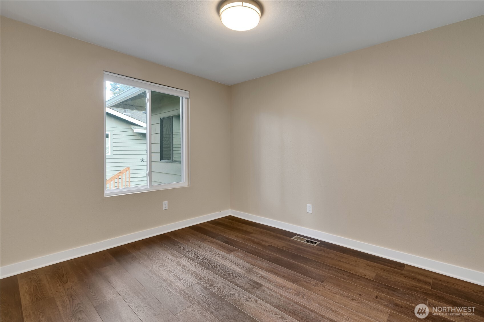 32417 29th Avenue Southwest Federal Way, WA 98023 - Photo 20 of 39 an empty room with wooden floor and windows