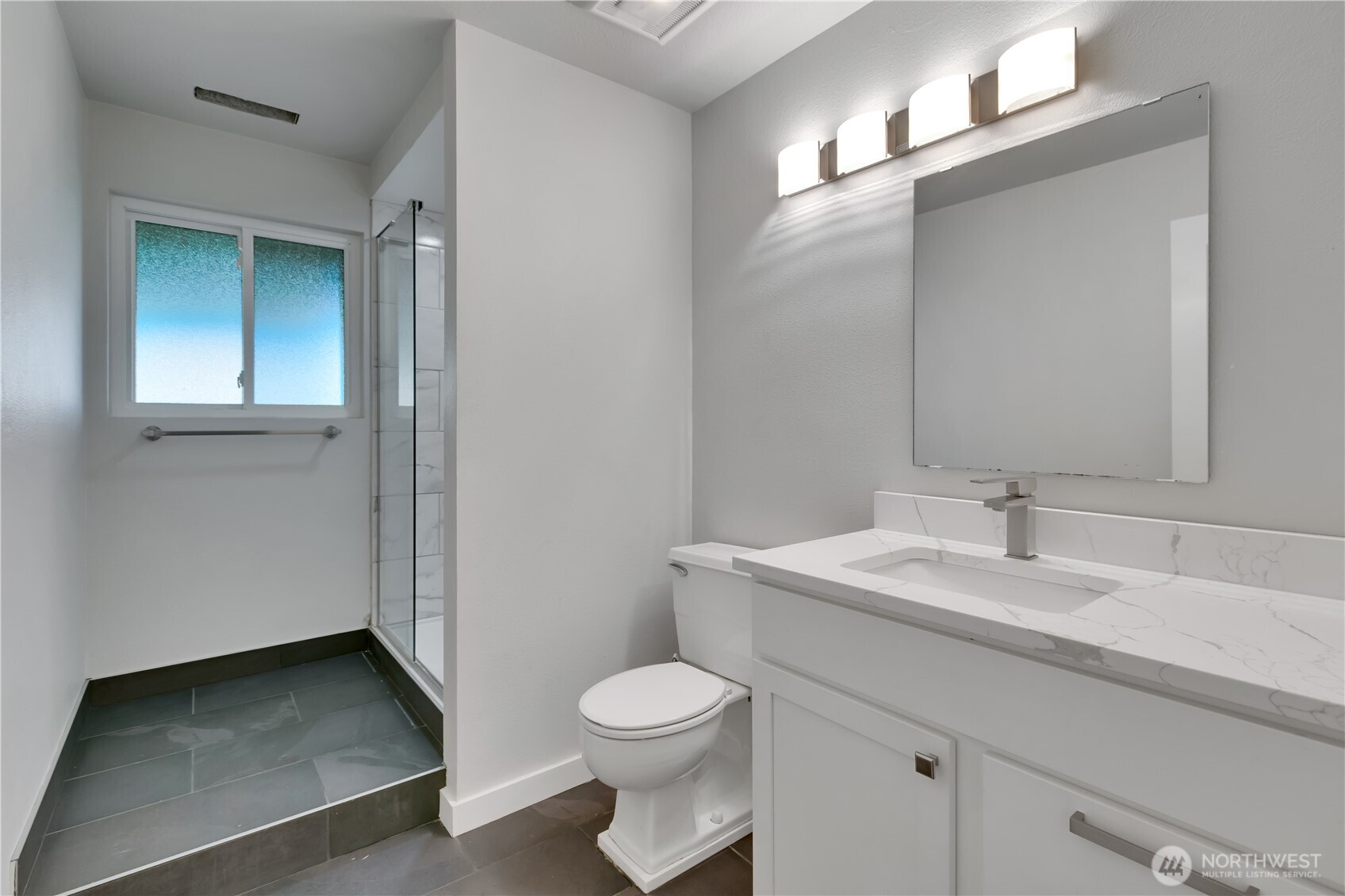 32417 29th Avenue Southwest Federal Way, WA 98023 - Photo 27 of 39 a bathroom with a toilet a sink and mirror