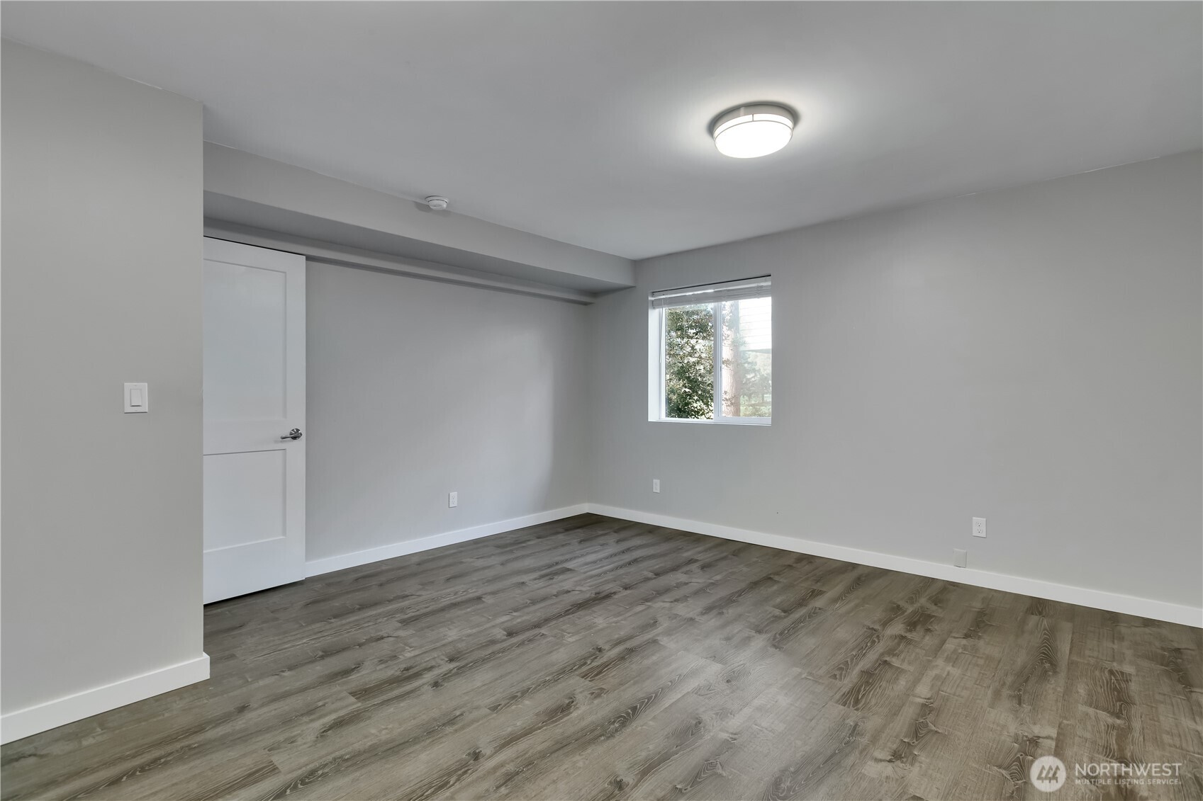 32417 29th Avenue Southwest Federal Way, WA 98023 - Photo 29 of 39 an empty room with wooden floor and windows