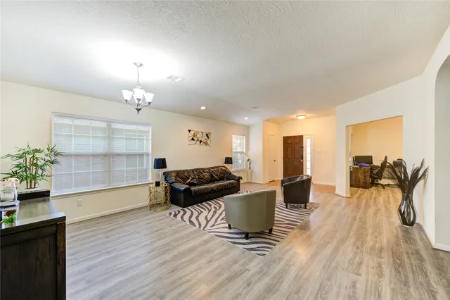 a living room with furniture a wooden floor and a window