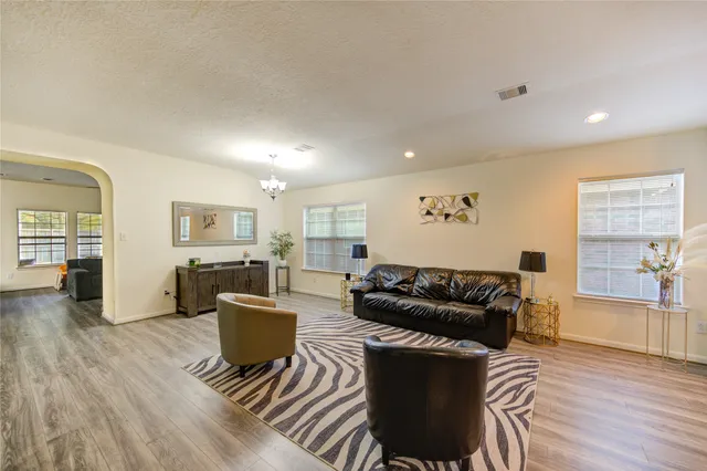 a kitchen with stainless steel appliances a dining table chairs and a refrigerator