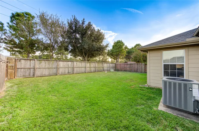 a view of a backyard with a garden and deck