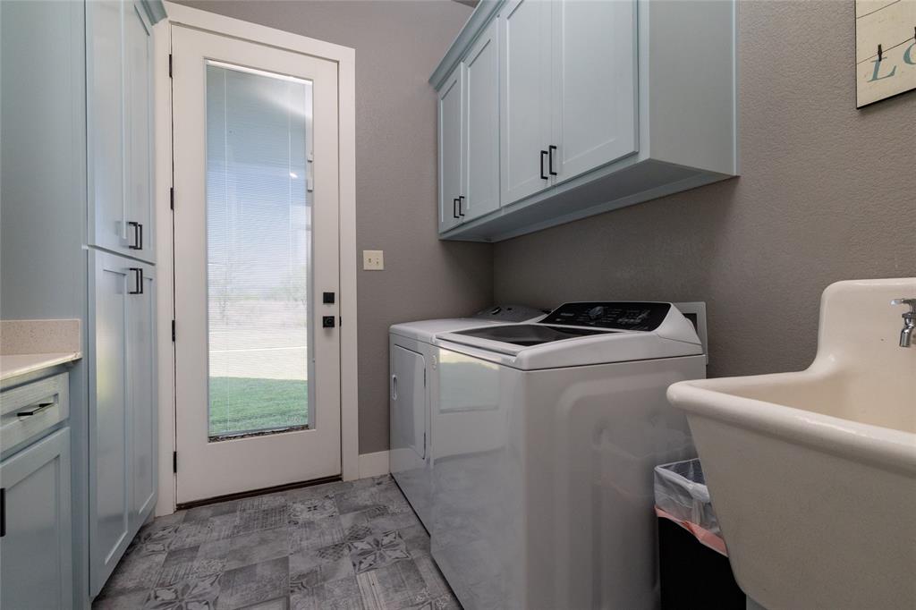 338 County Road 4223 Decatur, TX 76234 - Photo 28 of 37 Laundry Room w sink and storage, located on first floor. The door leads to the backyard pool area.