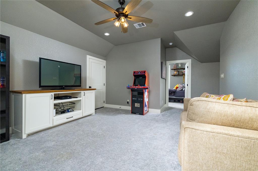 338 County Road 4223 Decatur, TX 76234 - Photo 30 of 37 Upstairs Game Room toward Bedroom 4 of 4 and located over the Garage for peace and quiet. The door beyond the TV is attic access.